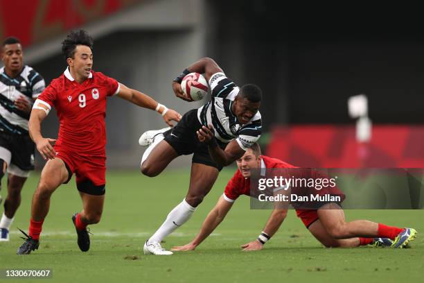 Jiuta Wainiqolo of Team Fiji makes a break to score a try during the Men's Pool B Rugby Sevens match between Fiji and Canada on day three of the...