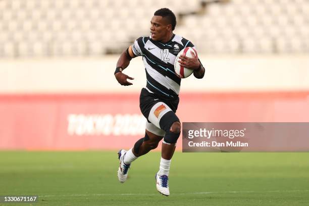 Napolioni Bolaca of Team Fiji makes a break to score a try during the Men's Pool B Rugby Sevens match between Fiji and Canada on day three of the...