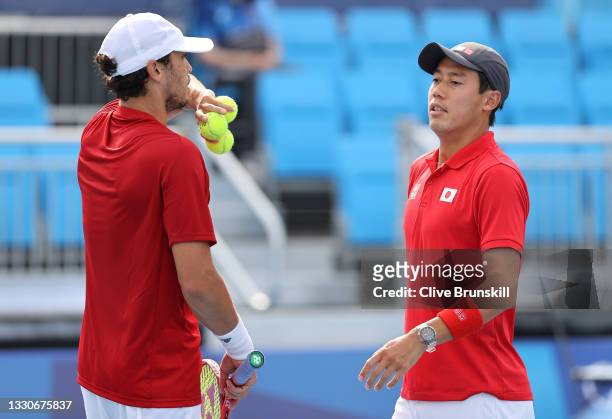Kei Nishikori of Team Japan and Ben McLachlan of Team Japan play Jamie Murray of Team Great Britain and Neal Skupski of Team Great Britain in their...