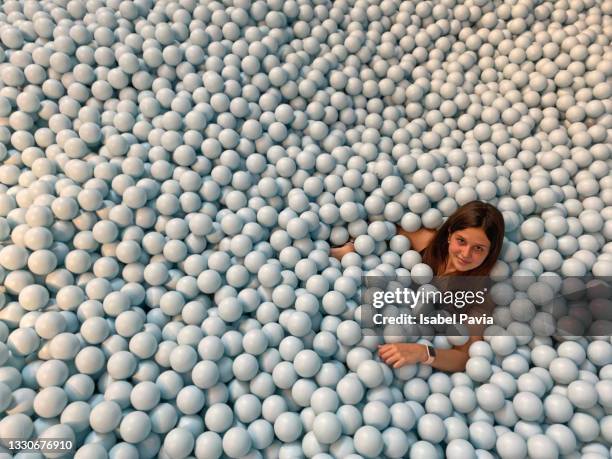 hispanic young woman in balls pool - human pool table stock pictures, royalty-free photos & images