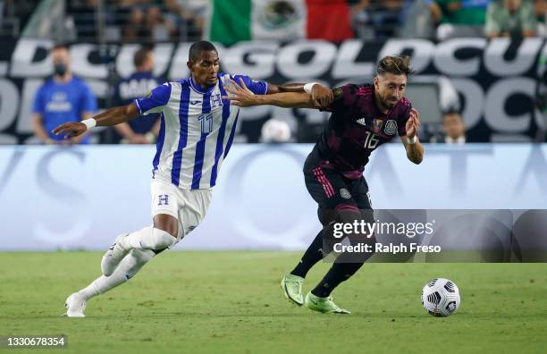 Hector Herrera of Mexico advances the ball as Jerry Bengtson of Honduras defends during the first half of the Concacaf Gold Cup quarterfinal match at...