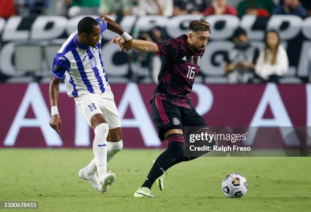 Hector Herrera of Mexico advances the ball as Jerry Bengtson of Honduras defends during the first half of the Concacaf Gold Cup quarterfinal match at...