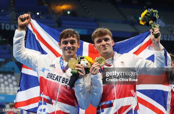 Thomas Daley and Matty Lee of Team Great Britain pose for photographers with their gold medals after winning the Men's Synchronised 10m Platform...