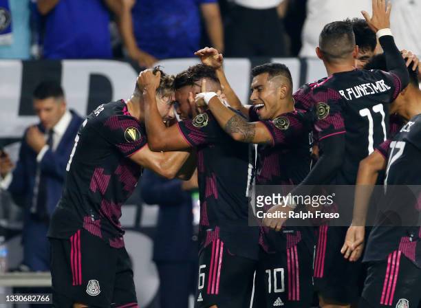 Jonathan Dos Santos of Mexico celebrates with Hector Herrera and Orbelin Pineda of Mexico after scoring a goal against Honduras during the first half...