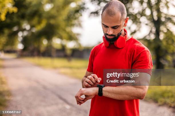 athlete check fitness tracker after training in nature - homens de idade mediana imagens e fotografias de stock