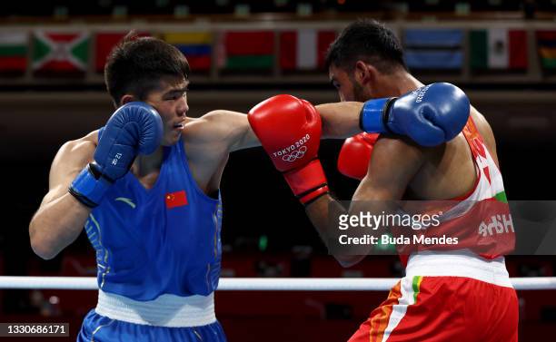 Ashish Kumar of India exchanges punches with Erbieke Tuoheta of China during the Men's Middle on day three of the Tokyo 2020 Olympic Games at...