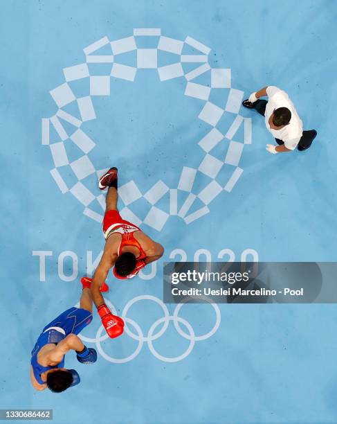 Ashish Kumar of India exchanges punches with Erbieke Tuoheta of China during the Men's Middle on day three of the Tokyo 2020 Olympic Games at...