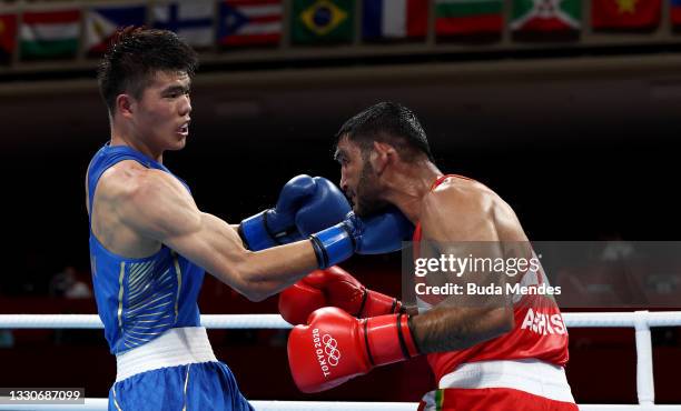 Ashish Kumar of India exchanges punches with Erbieke Tuoheta of China during the Men's Middle on day three of the Tokyo 2020 Olympic Games at...