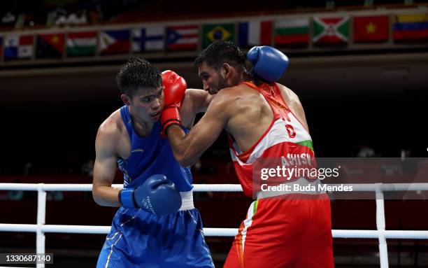 Ashish Kumar of India exchanges punches with Erbieke Tuoheta of China during the Men's Middle on day three of the Tokyo 2020 Olympic Games at...