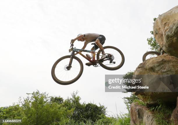 Anton Cooper of Team New Zealand jumps off a boulder during the Men's Cross-country race on day three of the Tokyo 2020 Olympic Games at Izu Mountain...