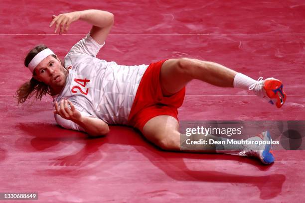 Mikkel Hansen of Team Denmark reacts after falling to the ground during the Men's Preliminary Round Group B match between Egypt and Denmark on day...