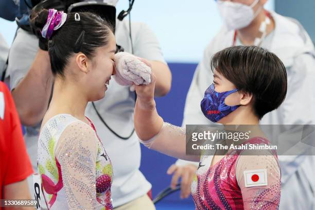 Hitomi Hatakeda of Team Japan is consoled by Mai Murakami after competing in the Uneven Bars exercise during the Women's qualification on day two of...