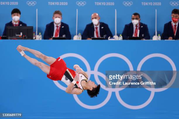 Takeru Kitazono of Team Japan competes in the floor exercise as judges look on during the Men's Team Final on day three of the Tokyo 2020 Olympic...