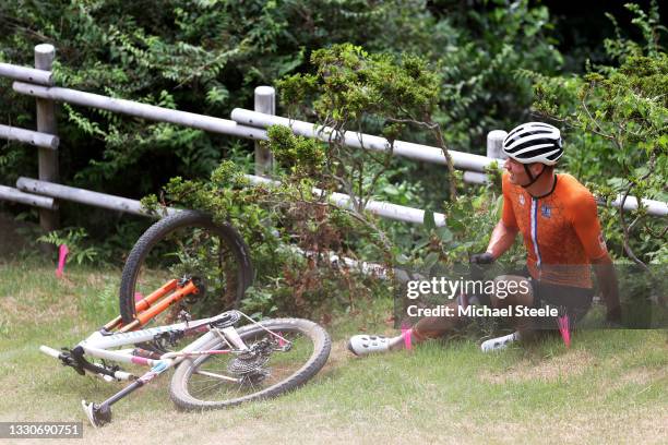 Mathieu van der Poel of Team Netherlands suffers a fall after jumps off a boulder during the Men's Cross-country race on day three of the Tokyo 2020...