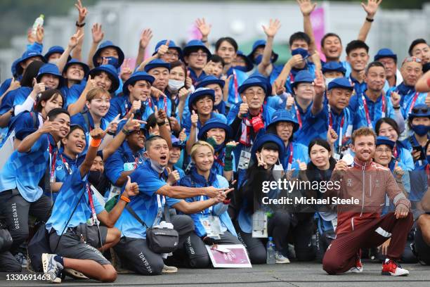 Mathias Flueckiger of Team Switzerland celebrates winning the silver medal and pose with Japanese fans after the Men's Cross-country race on day...