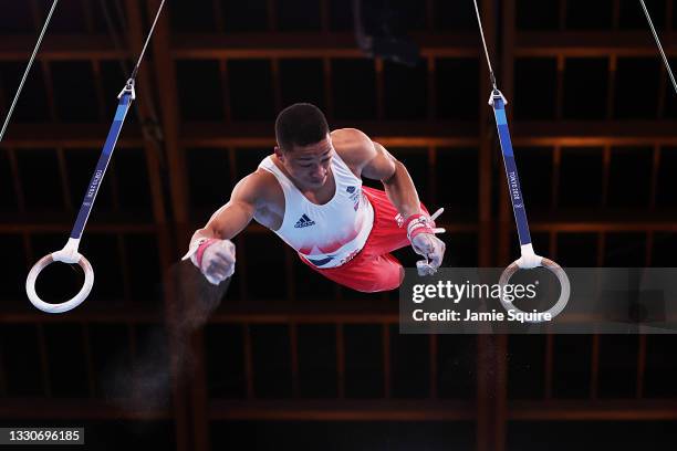 Joe Fraser of Team Great Britain dismounts from the rings during the Men's Team Final on day three of the Tokyo 2020 Olympic Games at Ariake...