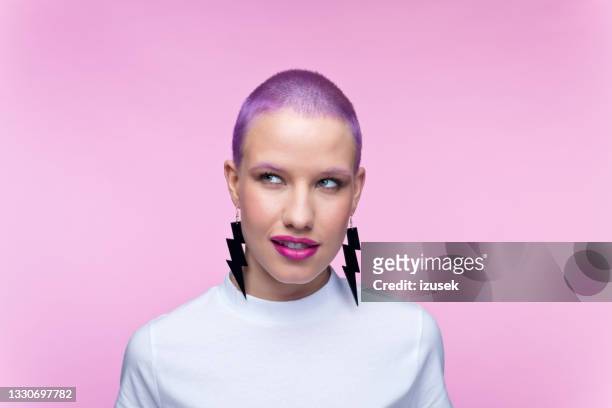 headshot de femme avec des cheveux violets courts et des boucles d’oreilles - femme make up mauve photos et images de collection