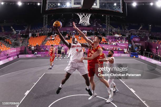 Michael Hicks of Team Poland drives to the basket under pressure from Jinqiu Hu of Team China in the 3x3 Basketball competition on day three of the...