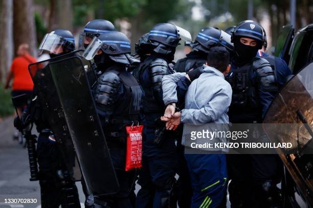 Police officers arrest a man during protests in Lille, northern France, on June 29 two days after a teenager was shot dead during a police traffic...