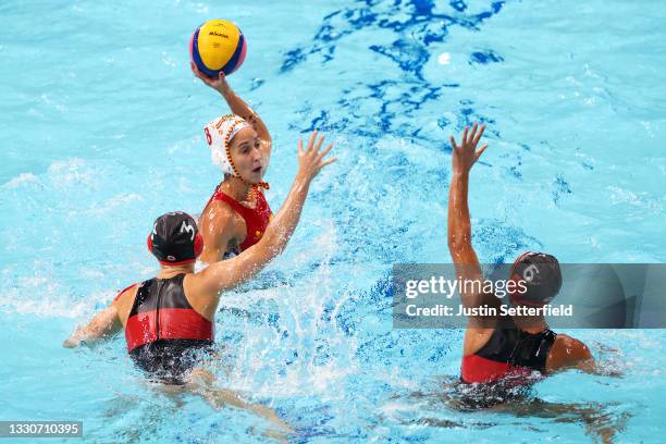 Pili Pena of Team Spain attempts to evade Axelle Crevier and Gurpreet Sohi of Team Canada during the Women's Preliminary Round Group A match between...