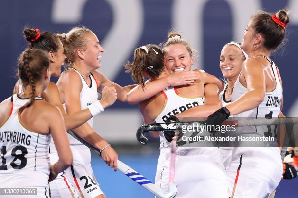 Nike Lorenz of Team Germany celebrates with team mates, embracing Cecile Pieper after scoring their team's first goal during the Women's Preliminary...