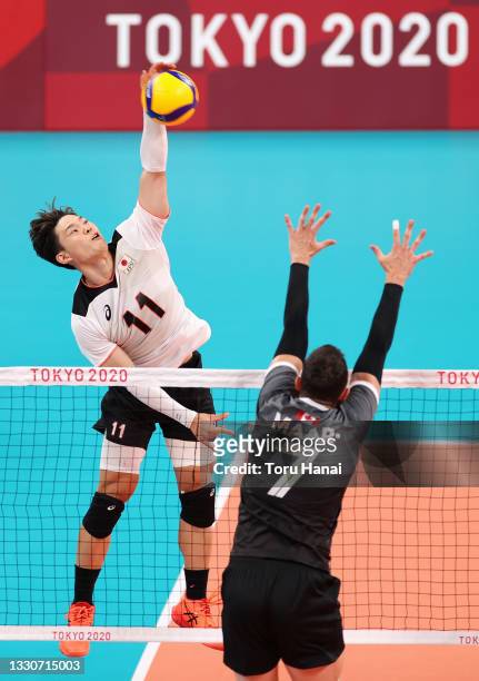 Yuji Nishida of Team Japan competes against Stephen Timothy Maar of Team Canada during the Men's Preliminary Round - Pool A volleyball on day three...