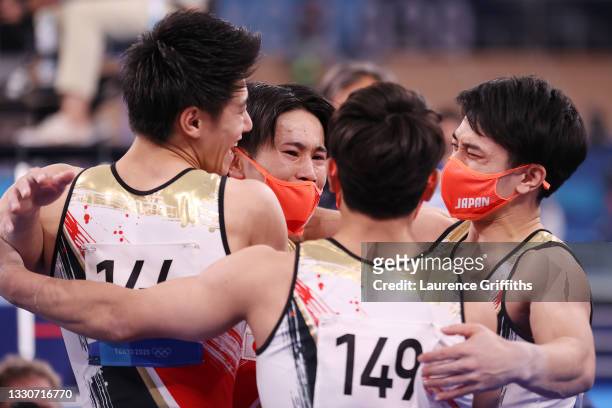 Team Japan celebrates after winning silver during the Men's Team Final on day three of the Tokyo 2020 Olympic Games at Ariake Gymnastics Centre on...