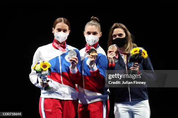 Silver medalist Sofya Velikaya of Team ROC, gold medalist Sofia Pozdniakova of Team ROC, and bronze medalist Manon Brunet of Team France, pose on the...