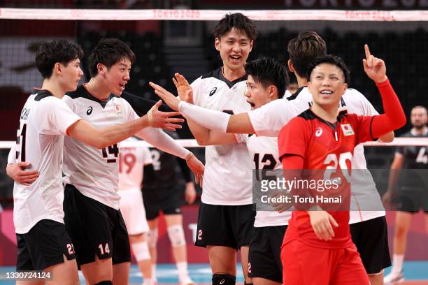 Players from Team Japan react as they compete against Team Canada during the Men's Preliminary Round - Pool A volleyball on day three of the Tokyo...