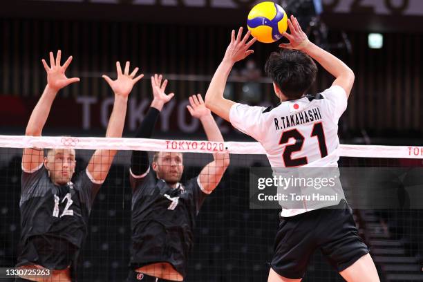 Ran Takahashi of Team Japan competes against Stephen Timothy Maar and Lucas van Berkel of Team Canada during the Men's Preliminary Round - Pool A...