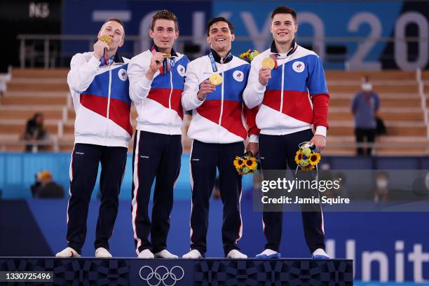 Denis Abliazin, David Belyavskiy, Artur Dalaloyan and Nikita Nagornyy of Team ROC pose with the gold medal on the podium during the medal ceremony...