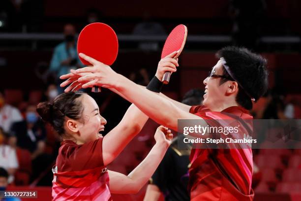 Ito Mima and Jun Mizutani of Team Japan celebrate after winning their Mixed Doubles Gold Medal match on day three of the Tokyo 2020 Olympic Games at...