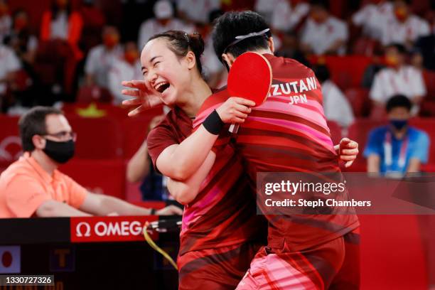 Ito Mima and Jun Mizutani of Team Japan embrace after winning their Mixed Doubles Gold Medal match on day three of the Tokyo 2020 Olympic Games at...