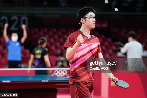 Jun Mizutani of Japan reacts against Xu Xin and Liu Shiwen of China in the Mixed Doubles Gold Medal Match on day three of the Tokyo 2020 Olympic...