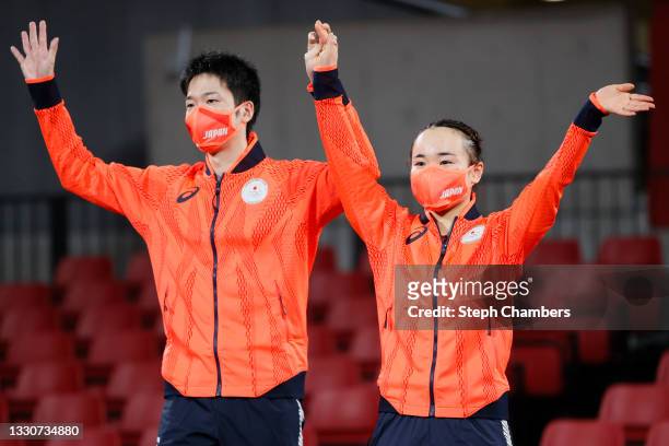 Ito Mima and Jun Mizutani and Ito Mima of Team Japan wave during the medal ceremony for the Mixed Doubles table tennis on day three of the Tokyo 2020...