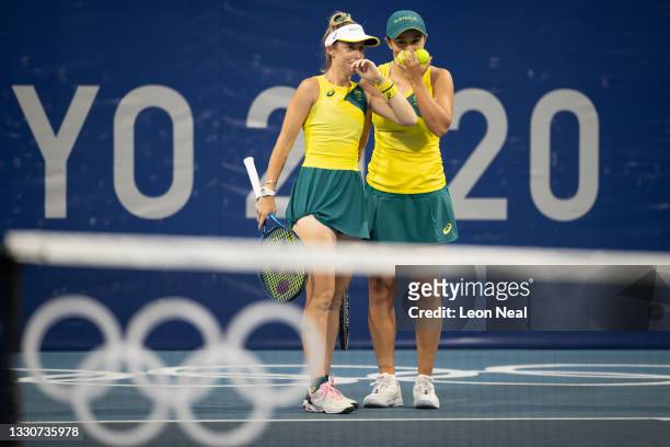 Ashleigh Barty of Team Australia and Storm Sanders of Team Australia discuss tactics as they play Yifan Xu of Team China and Zhaoxuan Yang of Team...