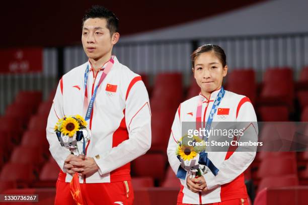 Xu Xin and Liu Shiwen of Team China on the podium during the Mixed Doubles medal ceremony on day three of the Tokyo 2020 Olympic Games at Tokyo...