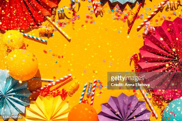 illuminating yellow festive background with multicolored confetti, colorful paper craft figures, balls and straws and copy space. trendy colors of the year. festive concept - fiesta stock-fotos und bilder