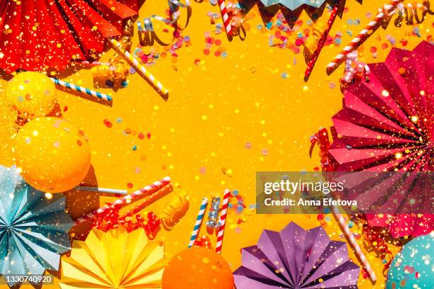 illuminating yellow festive background with multicolored confetti, colorful paper craft figures, balls and straws and copy space. trendy colors of the year. festive concept - decorative balloons ストックフォトと画像