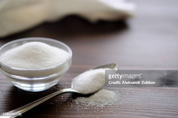 natural seasoning, organic, sea, small and large, white salt in a spoon, in a cup, in a salt shaker, poured on a wooden table. next to the linen towel. the concept of cooking healthy food, cosmetology, spa services, spa care. - bowl of sugar stockfoto's en -beelden