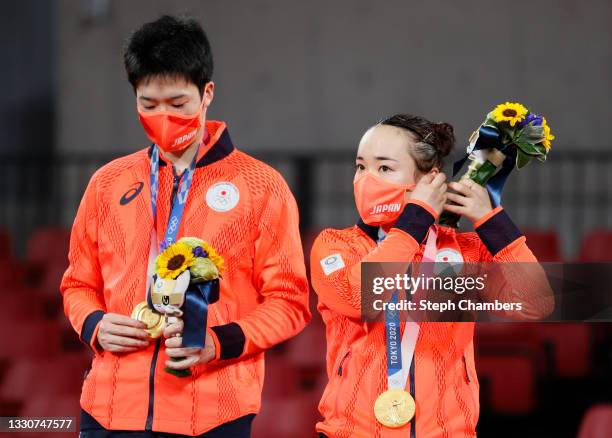Ito Mima and Jun Mizutani and Ito Mima of Team Japan pose with their medals after winning their Mixed Doubles Gold Medal match on day three of the...