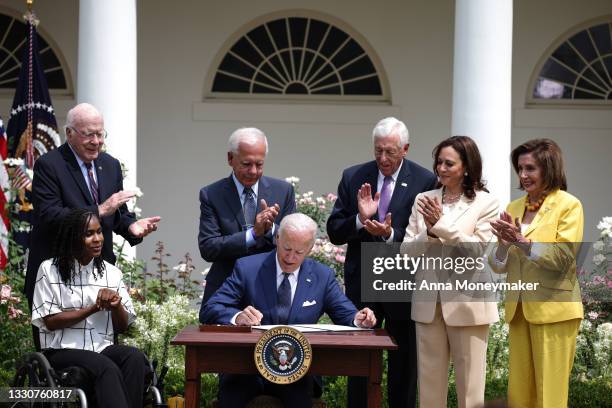 President Joe Biden signs a proclamation on the anniversary of the Americans with Disabilities Act , as artist Tyree Brown, Sen. Pat Leahy , former...