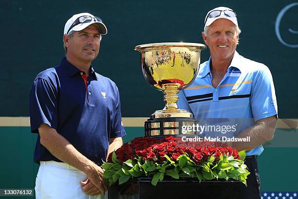 Team captain Fred Couples and International Team captain Greg Norman stand alongside the Presidents Cup prior to the start of the Day One Foursome...