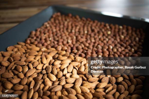 roasted hazelnuts and almonds - roasted almonds stock pictures, royalty-free photos & images