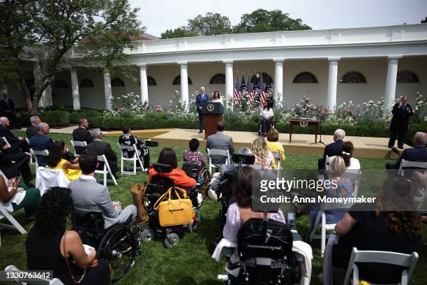 Vice President Kamala Harris delivers remarks, as U.S. President Joe Biden looks on, in the Rose Garden of the White House on July 26, 2021 in...