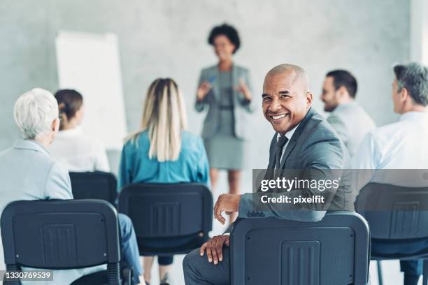 portrait of a businessman attending a conference - fato completo imagens e fotografias de stock