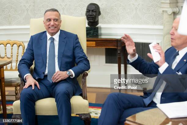 Iraqi Prime Minister Mustafa Al-Kadhimi listens as U.S. President Joe Biden speaks during a bilateral meeting in the Oval Office at the White House...