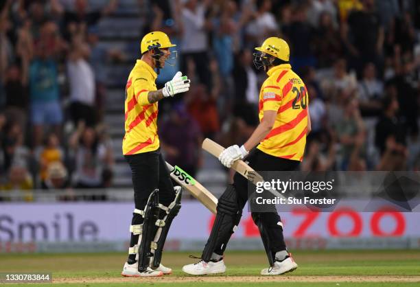 Rocket batter Alex Hales celebrates with Matthew Carter after Hales had hit the winning runs during the Hundred match between Trent Rockets and...