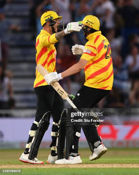 Rocket batter Alex Hales celebrates with Matthew Carter after Hales had hit the winning runs during the Hundred match between Trent Rockets and...