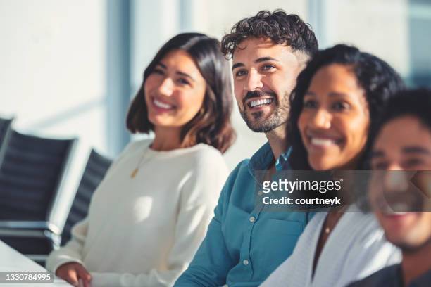 group of people listening to a presentation. - employee of the month stockfoto's en -beelden